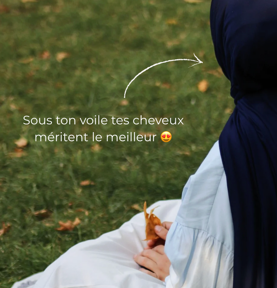 Femme voilée assise dans l'herbe, message : sous ton voile, tes cheveux méritent le meilleur